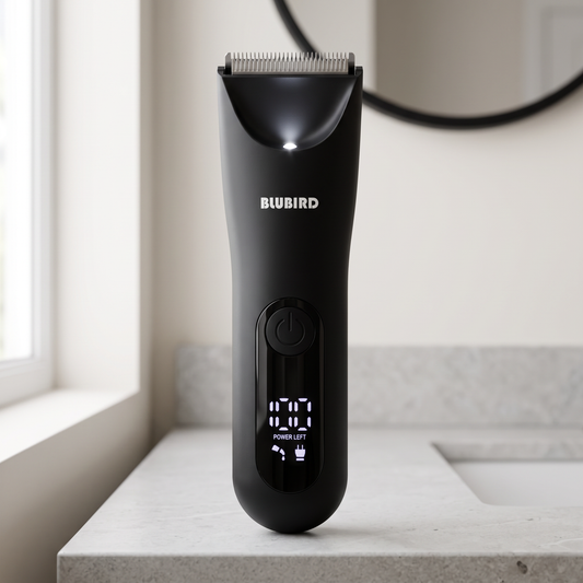 arm and leg hair grooming for men in Singapore, a matte black Blubird Trim Reaper body trimmer standing on a bright bathroom counter beside a round mirror, BLUBIRD wordmark visible on the product body