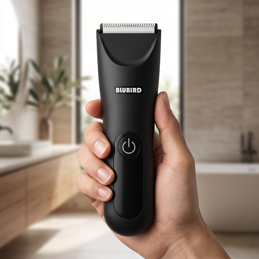 how to shave chest hair without the itch in Singapore, a matte black Blubird Trim Reaper body trimmer held in one hand in a bright modern bathroom, BLUBIRD wordmark visible on the body