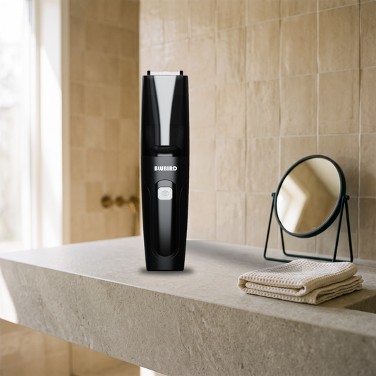 pubic hair styles for men, a glossy black Blubird Suckaa vacuum trimmer standing on a stone bathroom counter beside a folded towel in soft morning light
