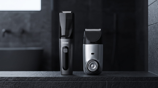 A Blubird Suckaa below the belt trimmer and a Blubird Hummingbird face shaver standing side by side on a dark slate bathroom shelf, BLUBIRD wordmark visible on the Suckaa body